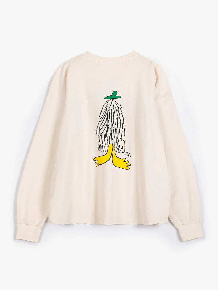 A cream-colored long-sleeve t-shirt with a graphic illustration of a banana split on the back, featuring a green hat, black hair, and yellow feet, displayed against a light gray background.
