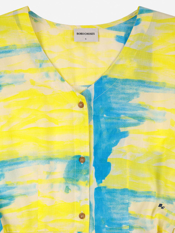 Vestit amb botons i coll en punta nacre perlat